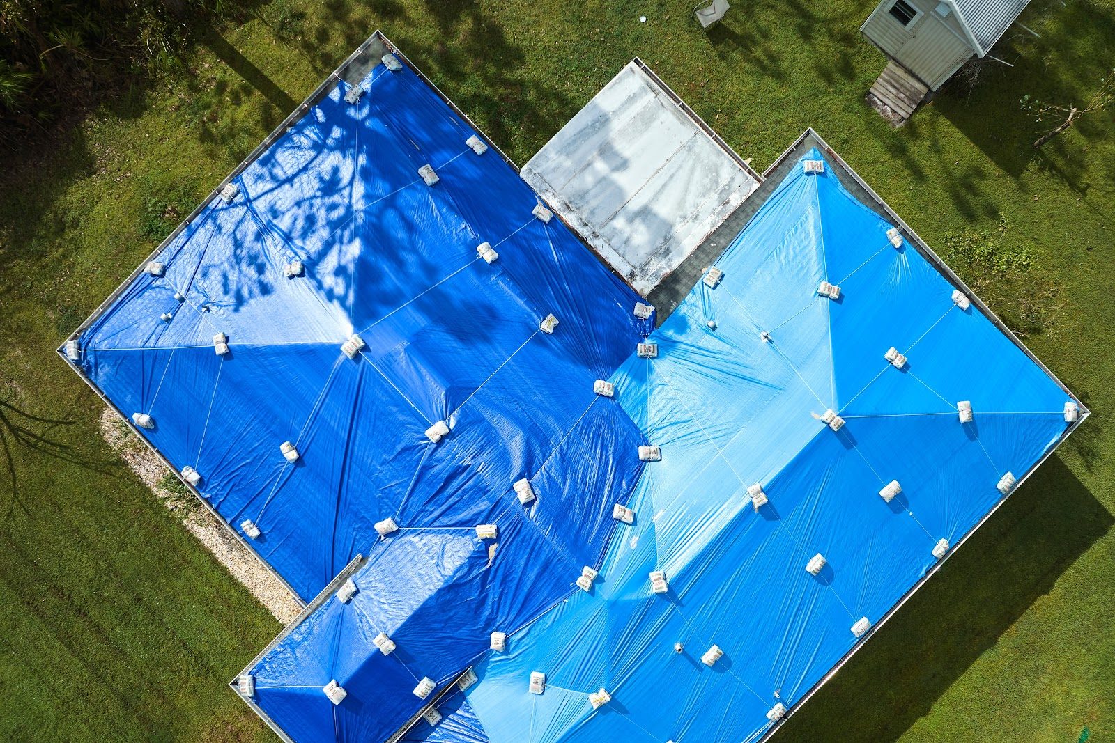 Aerial view of a Central Florida home fully tarped by Onsite Mitigation & Restoration after roof damage