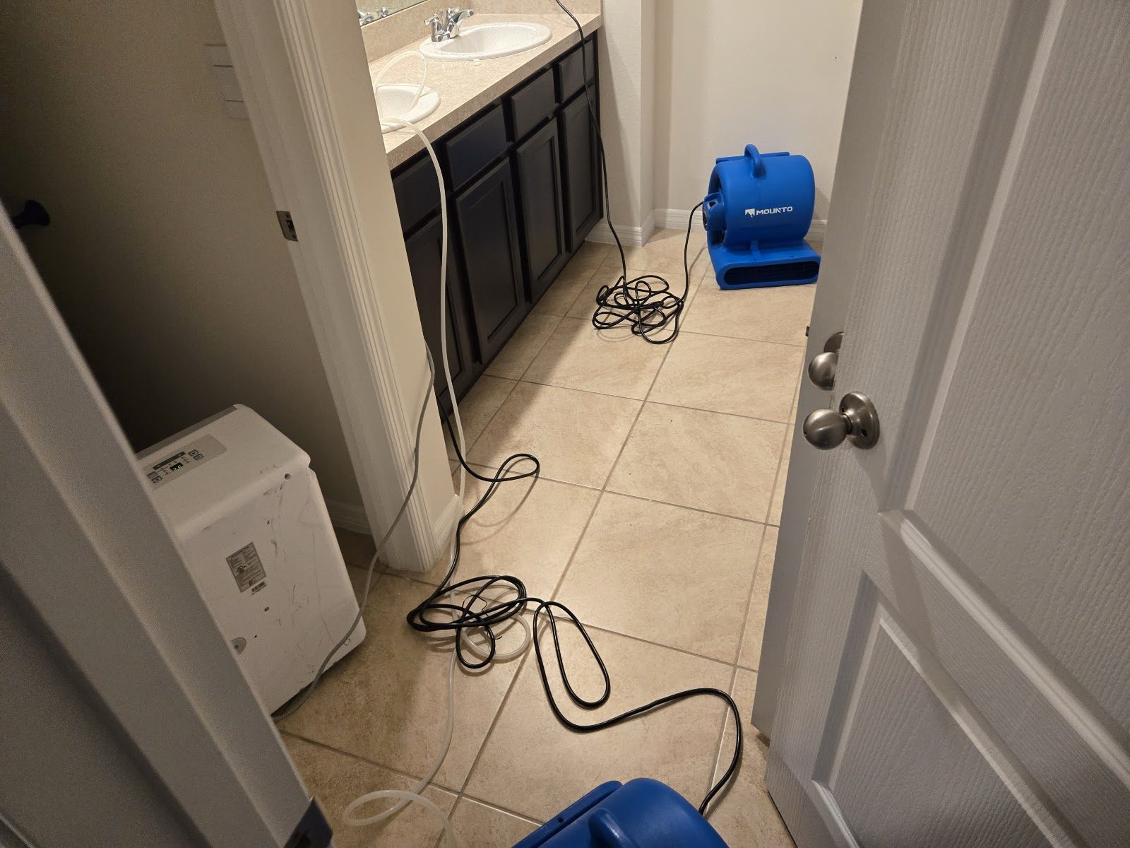 Onsite Mitigation & Restoration air movers drying a water-damaged Central Florida bathroom